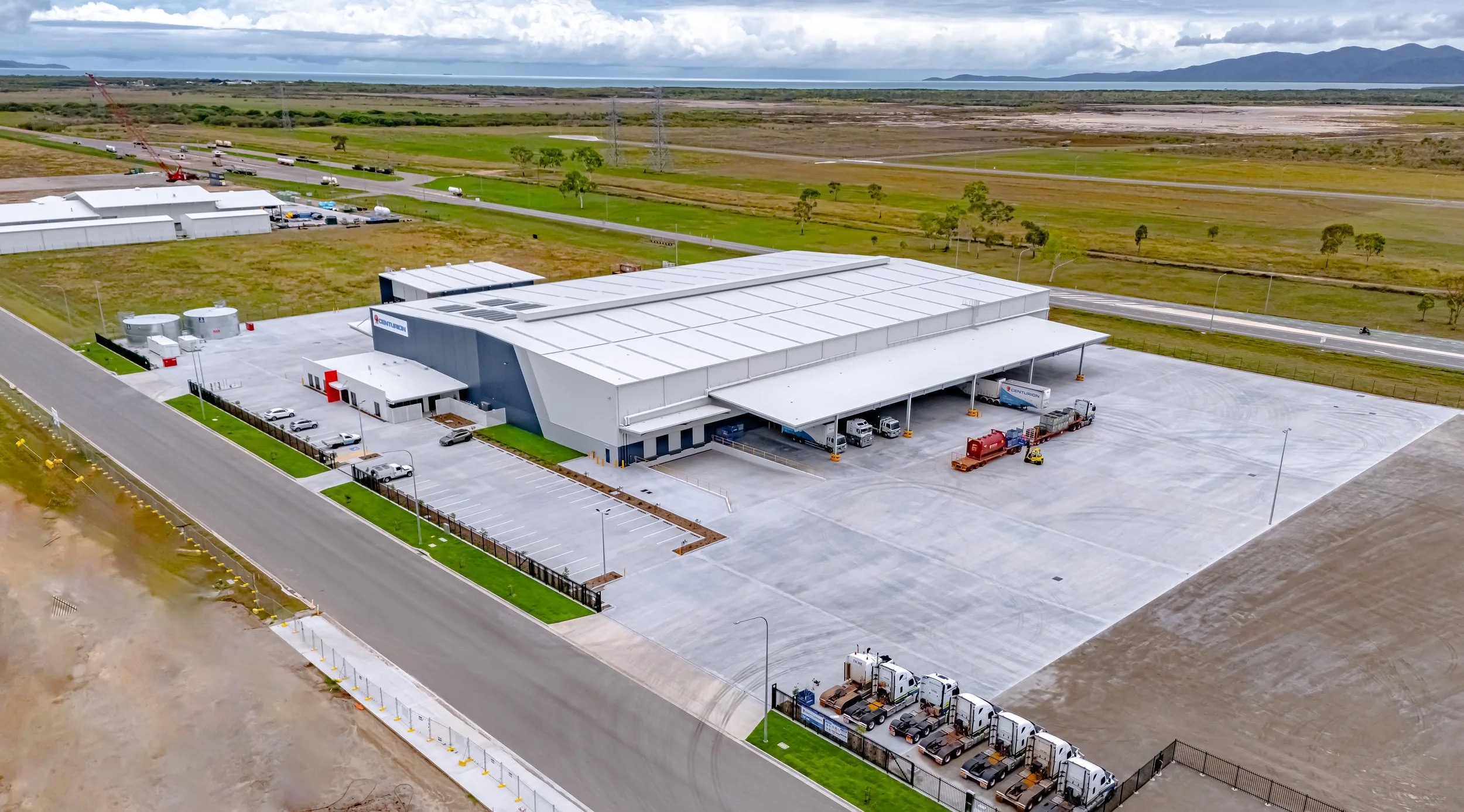 Aerial view of a large warehouse with a concrete hardstand yard